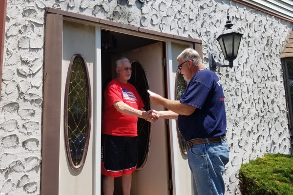 Point Bay Fuel technician greeting homeowner during HVAC service