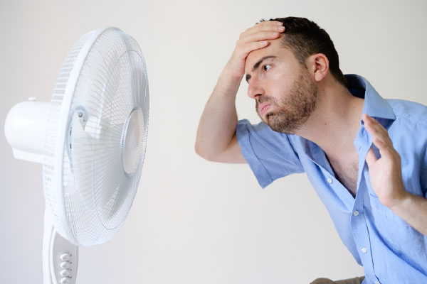 a homeowner feeling hot and sticky due to an air conditioner short cycling