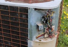image of an old air conditioning unit that needs an AC unit replacement
