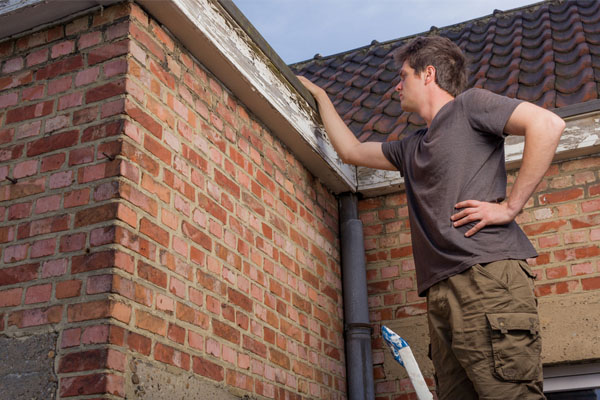 checking the condition of the home's roof