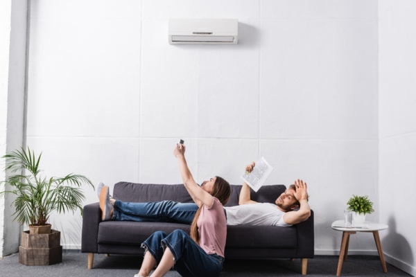 couple in front of ductless AC blowing warm air