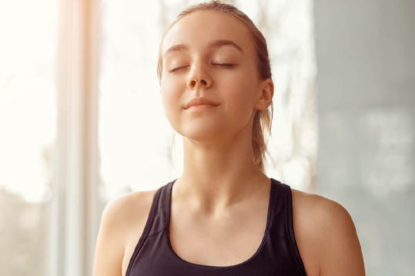 homeowner breathing deeply due to healthy indoor air quality