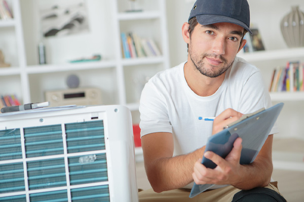 hvac contractor discussing heating and air conditioner installation plans with homeowner