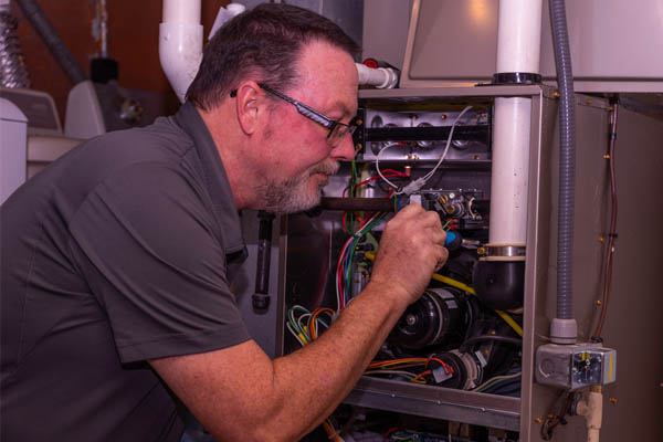 hvac contractor servicing a furnace