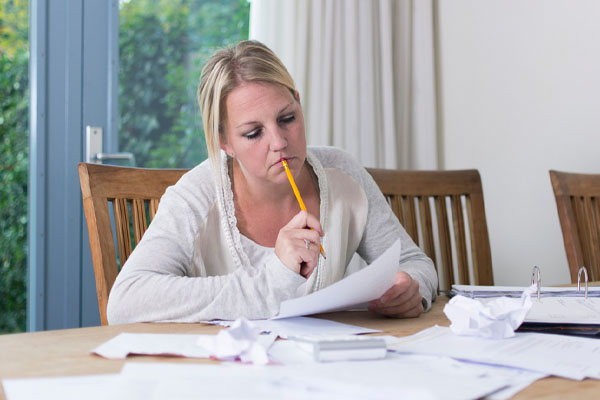 image of a homeowner calculating bills from cooling