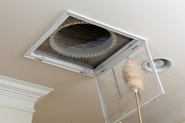 image of a homeowner cleaning hvac vent