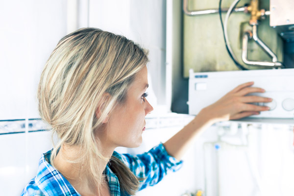 image of a homeowner inspecting their water boiler