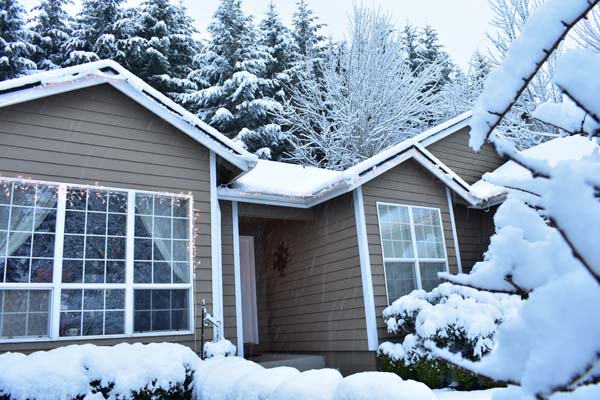 image of a house in winter that uses a boiler for home heating