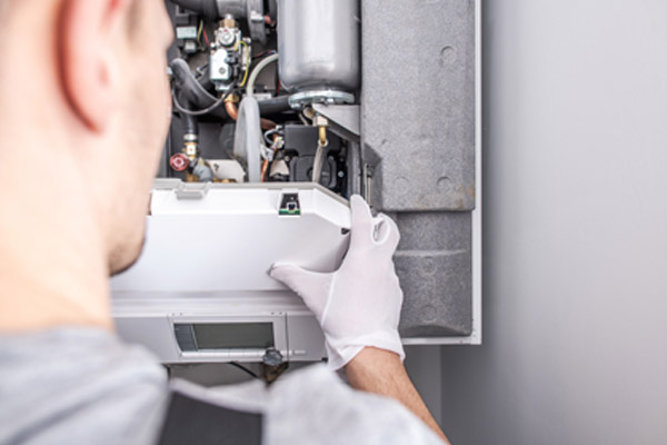 image of a hvac contractor installing a heating oil furnace with higher efficiency