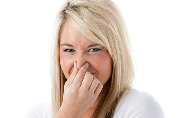 image of a woman noticing a bad odor at home