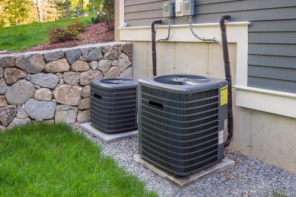 image of an air conditioner compressor and lawn