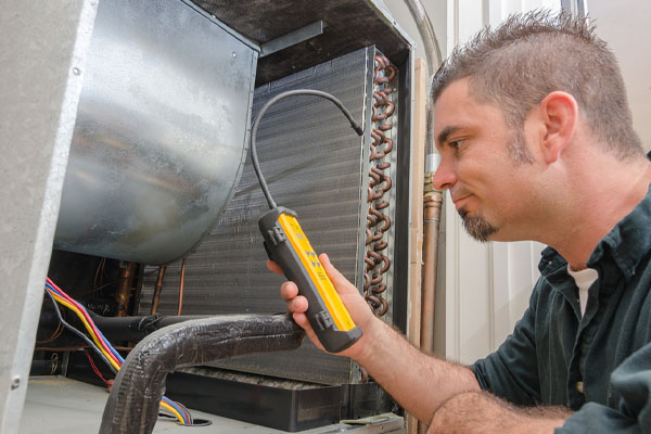 image of an hvac contractor examining refrigerant levels of a heat pump system