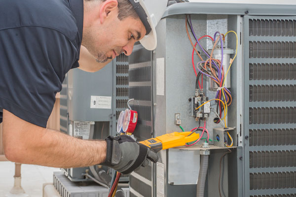 image of an hvac contractor performing ac capcitor repair