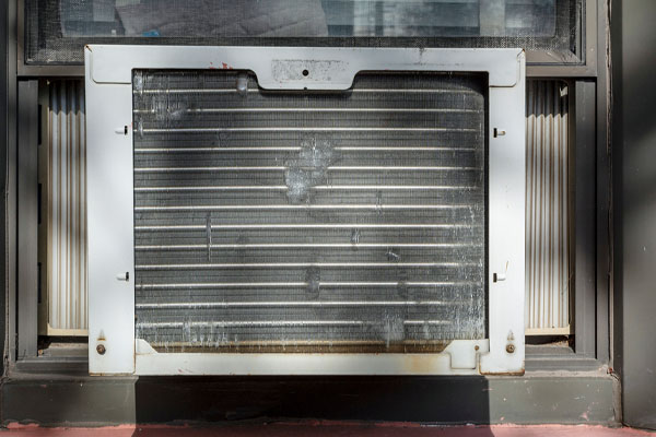 image of an old and inefficient window air conditioner