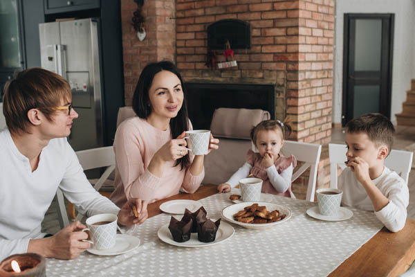 image of family spending time at table depicting home comfort with natural gas heating in neptune nj