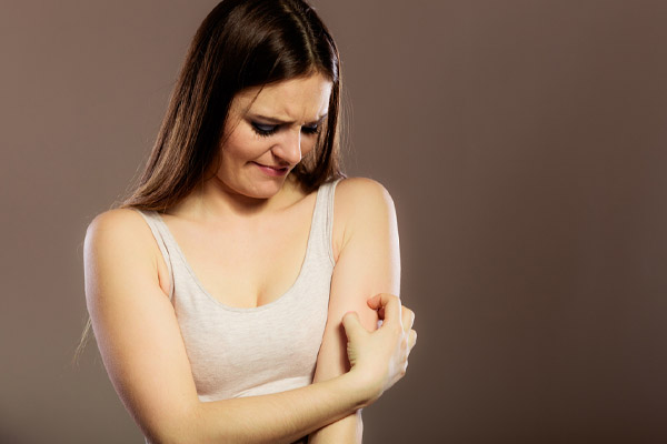 image of homeower scrathing itchy skin due to hvac system