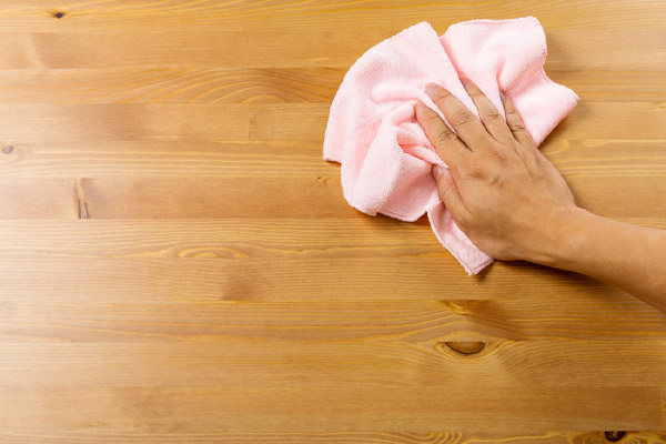 image of homeowner removing dust from home to improve indoor air quality