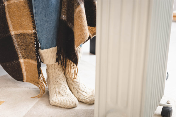 image of homeowner using space heater during a home heating emergency