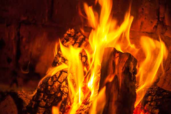 image of logs buring in a home fireplace