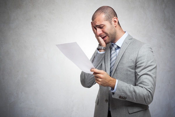 image of man looking at heater maintenance costs