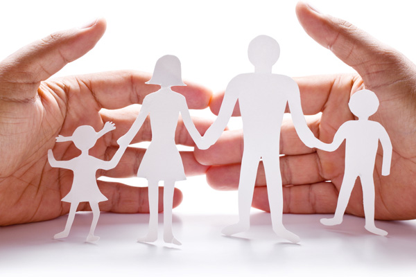 image of paper cut out of family in hands depicting furnace safety