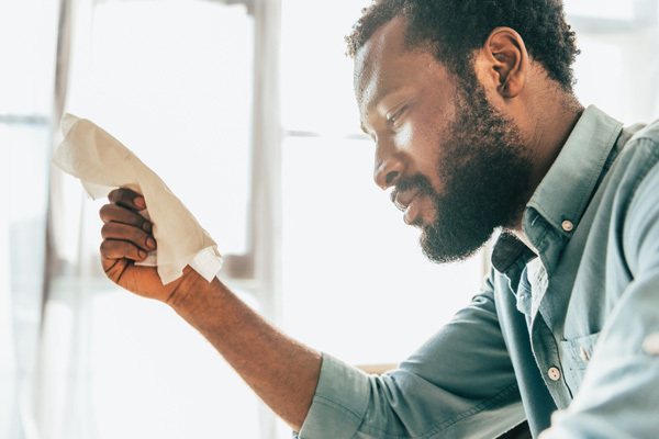 man suffering from high humidity at home