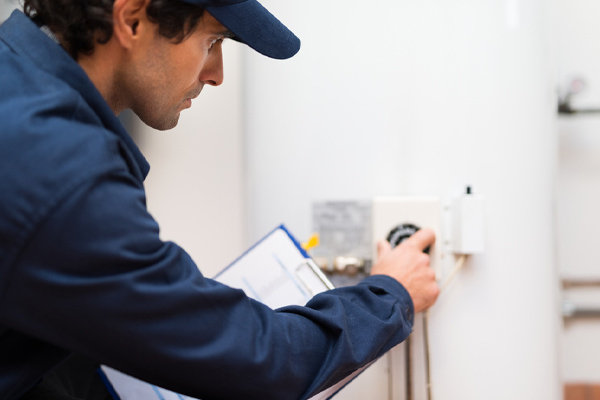 plumber installing an electric water heater in nj