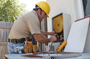 toms river heating and cooling technician doing a repair